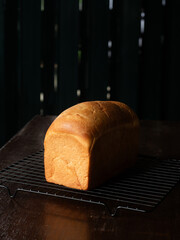 loaf of white sandwich bread on black cooling rack