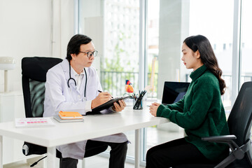Doctor talking to patient and filling patient history, examination, treatment, medical and health concept.
