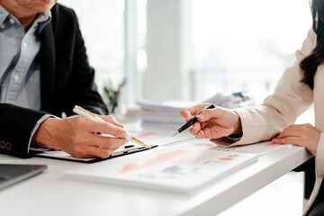 Business people are having a meeting to analyze data figures to plan business strategies, brainstorm financial ideas to invest in new business projects.