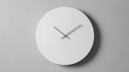 A minimalist white clock with silver hands on a gray wall showing the time in a clean and modern style