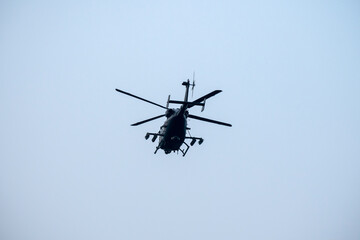 Helicopter is flying on isolated blue sky in mid-air background