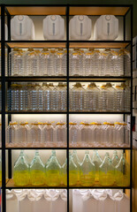 Plastic wine containers and bottles on display – refillable packaging in wine retail