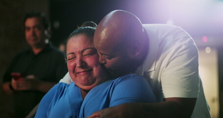 Person of African descent embraces woman in emotional moment of joy and laughter, tender hug,...