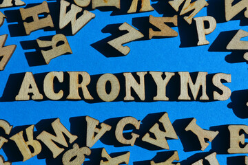 Acronyms, word surrounded by random alphabet letters on blue background