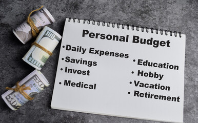 Concept of Personal budget write on book. with dollars inside on the table