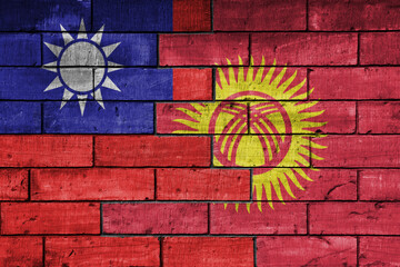 colourful painted big national flag of taiwan and flag of kyrgyzstan on a massive old brick wall background. concept