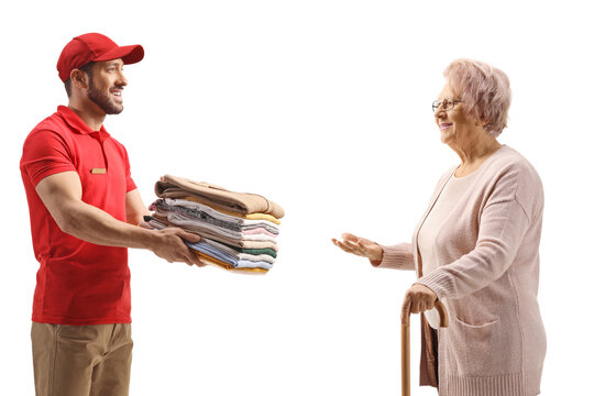Dry clean worker delivering a pile of clothes to an elderly woman