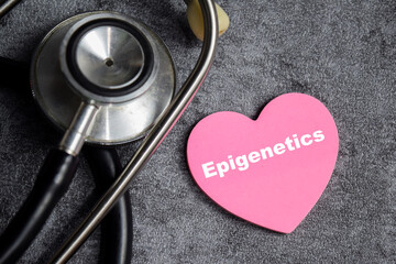 Concept of Epigenetics write on sticky notes isolated on Wooden Table. stethoscope and pharmaceuticals