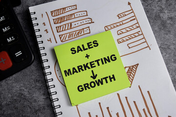Concept of Sales - marketing - growth write on sticky notes isolated on Wooden Table. stock and chart business concept