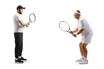 Coach practicing tennis with a mature man