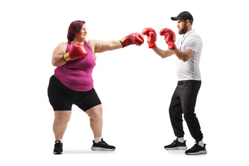 Corpulent woman training box with a coach