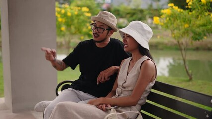 Tourists sitting on a bench enjoy their holidays and chat quietly - Powered by Adobe