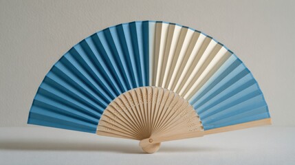 Ultra quality image of dual-color folding fan, blue and beige combination, minimalist design, white background.