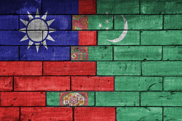 colourful painted big national flag of taiwan and flag of turkmenistan on a massive old brick wall background. concept