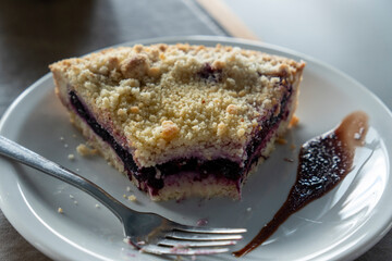 Homemade shortcrust fruit pie with crumble on white background - homemade pastry with fruit or...