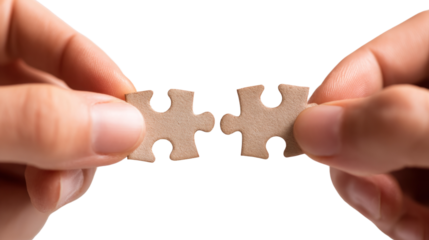 Finding the Missing Piece: A close-up shot capturing two hands aligning puzzle pieces, symbolizing problem-solving, teamwork, and collaboration.