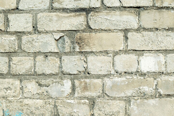 Old dirty peeling white brick wall.