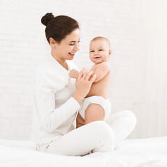 Happy time of motherhood. Young mother holding her cute baby, panorama with empty space