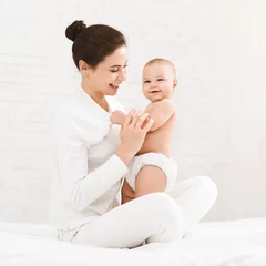 Gordijnen Happy time of motherhood. Young mother holding her cute baby, panorama with empty space © Prostock-studio