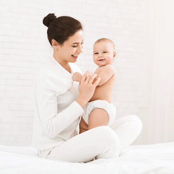 Fototapeta Happy time of motherhood. Young mother holding her cute baby, panorama with empty space