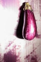 A striking eggplant is painted on a textured urban wall, surrounded by an array of vibrant colors. This unique graffiti piece transforms the ordinary into extraordinary, igniting artistic imagination