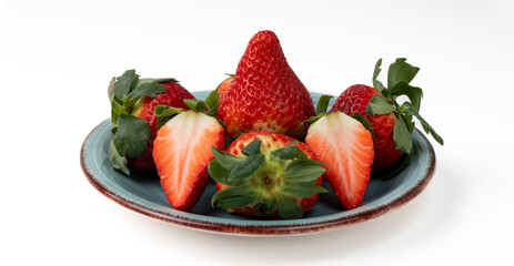 Plate of fresh strawberries on a white background
