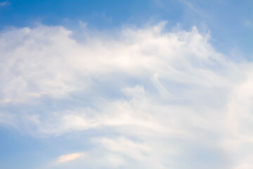 A blue sky with soft clouds.