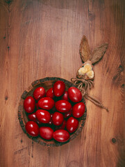 painted eggs in a wooden bowl, red, painted madder dye, powder from the roots of endro, with onion husks, top view, Easter, Georgia,