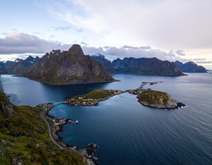 Fototapeta premium Aerial view of a fjord village nestled between dramatic peaks
