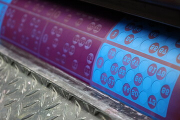printing of colored and numbered game cards called bingo in the printing house. selective focus