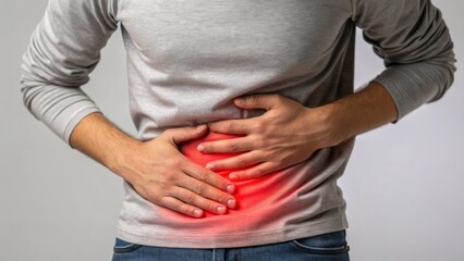 Gut Health and IBS Symptoms – Digestive Wellness Concept, A person holds their abdomen with one hand while looking contemplatively, indicating discomfort or reflection.