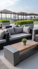 Fototapeta premium Spacious green garden hosts a sleek sofa and table, perfect for relaxation and socializing during the bright day in the city