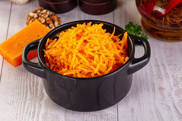 Yellow shredded cheddar cheese in the bowl