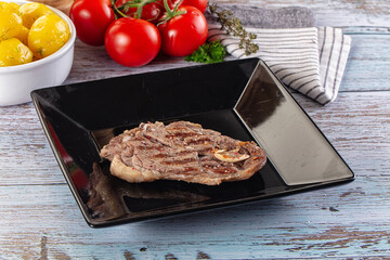 Grilled lamb steak with bone