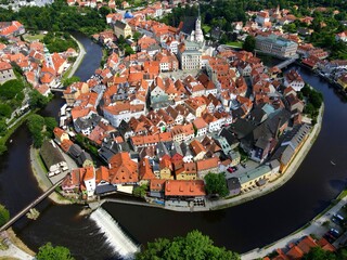 Panorama of Cesky Krumlov, Czech Republic. Red roofs and old medieval houses, water of Vltava River. View from drone, Krumlov