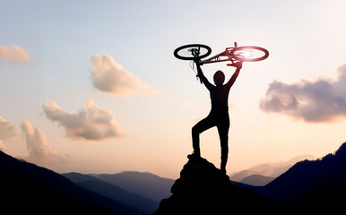 Diary of an adventurous man on his bike at sunset on top of the mountains