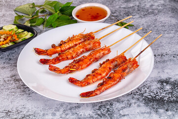 Grilled prawn skewer served sauce