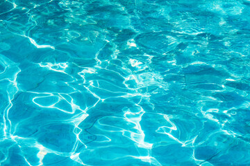 Blue water surface viewed from above in outdoor sea, sun reflection, dimply.