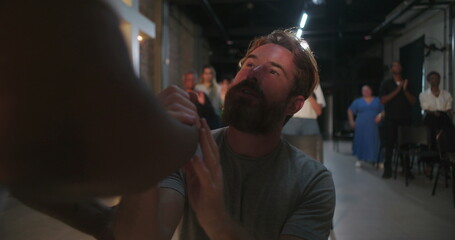 Man in emotional prayer, receiving spiritual support, hands on chest, eyes closed in devotion,...