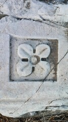 Stone carved shape of flower. Ancient architecture and architectural decor. Handmade stone carving 