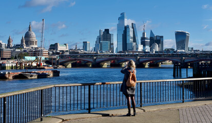 young woman on river thames bank in London