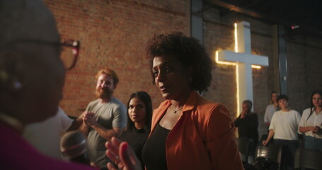 Congregation members embracing during a Christian event, sharing a moment of spiritual connection with love and support