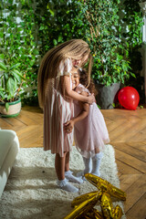girls, Sisters joyfully embracing each other in a lush and cozy living space filled with warmth