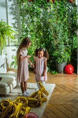 girls, Sisters joyfully embracing each other in a lush and cozy living space filled with warmth