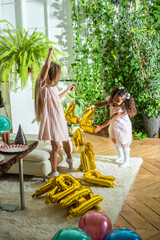 girls, Sisters joyfully embracing each other in a lush and cozy living space filled with warmth