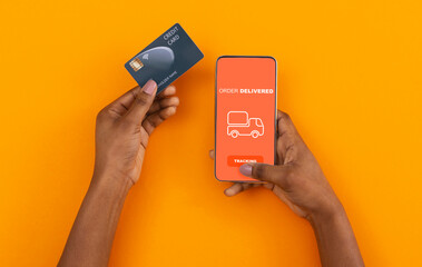 Stay at home, pay with credit card. African american man ordered with online app on cell phone,...