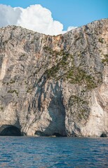 Visitors enjoy the stunning Zakynthos coastline, where azure waters meet rugged cliffs. The summer heat brings vibrant energy to this beautiful Greek destination, inviting exploration and relaxation