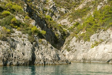 Kayaking through crystal-clear waters, surrounded by rugged cliffs and lush greenery, reveals the stunning natural beauty of Zakynthos during a warm summer day