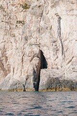 Kayaking along the crystal-clear waters reveals breathtaking coastal caves of Zakynthos, where sunlight dances on the limestone cliffs, creating a magical atmosphere