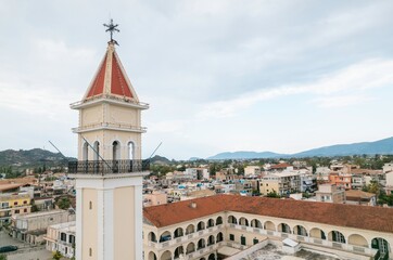 Nestled among stunning hills, Zakynthos showcases its charming architecture and vibrant local life during the summer. The warm sun illuminates historical buildings and lively streets